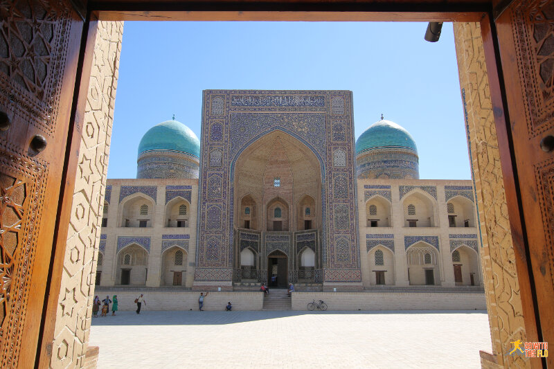 Mir-i-Arab Medressa seen through the doors of the Kalon Mosque