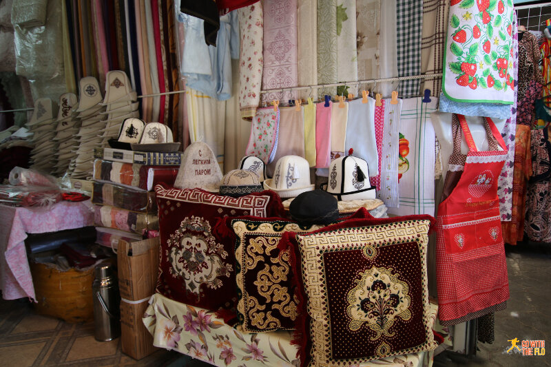 Stall inside Kelechek Bazaar selling traditional Kyrgyz hats