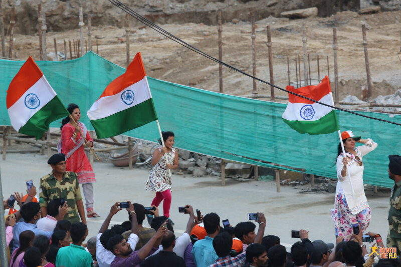 Pre-ceremony celebrations with flags and...