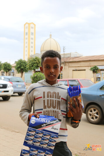 Boy selling pens